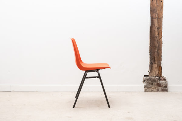 Stackable orange plastic patio chair